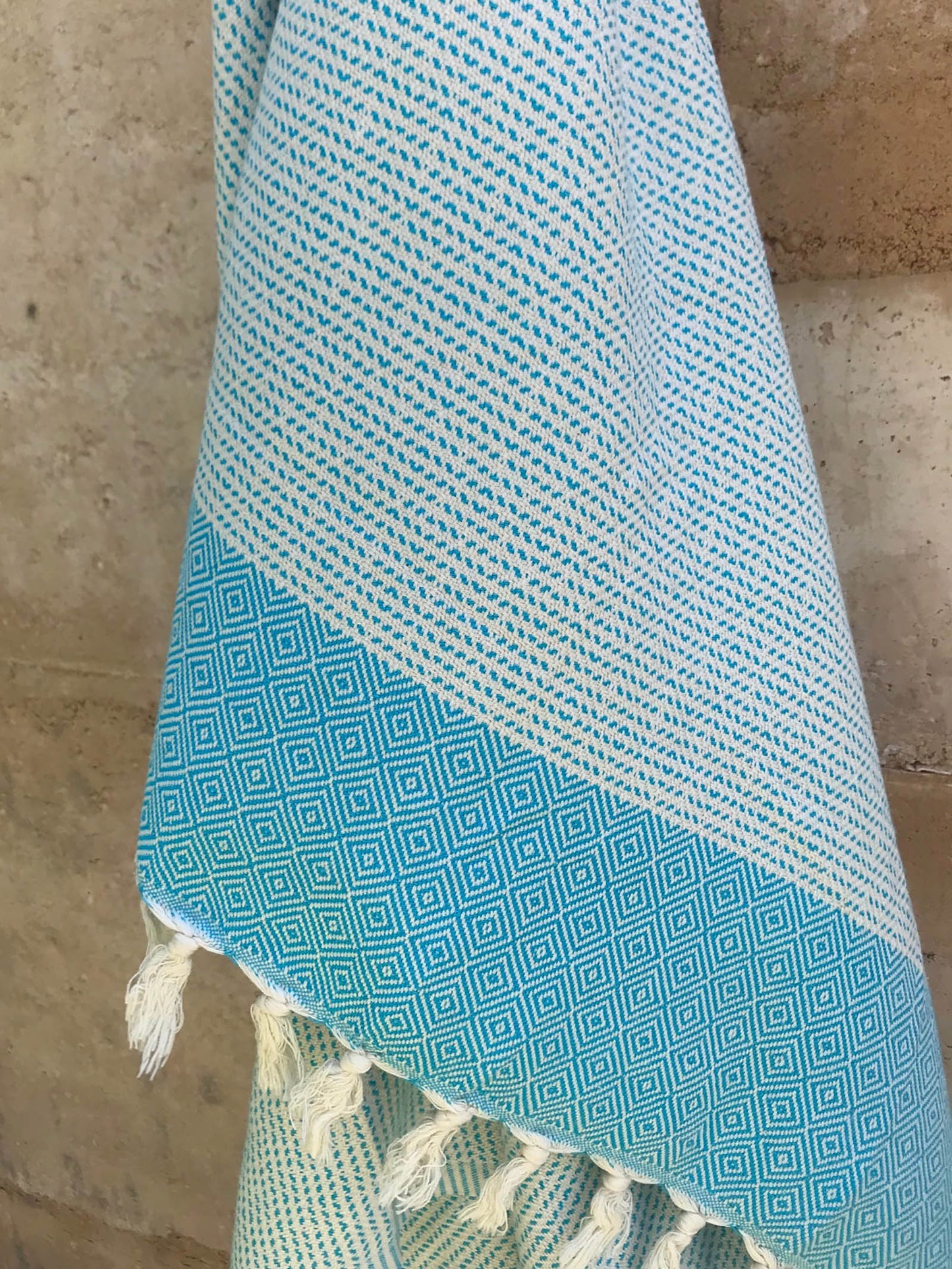 Freostyle Turkish Beach Towel with Pockets, Capri, Aqua Blue, hung on wall