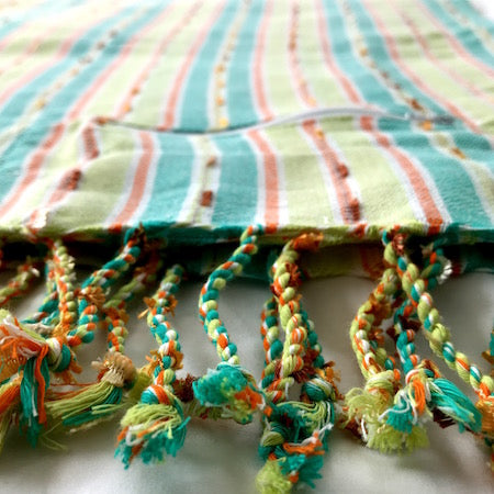 This authentic, ethically made turkish towel has stylish tassels and a handy hidden pocket