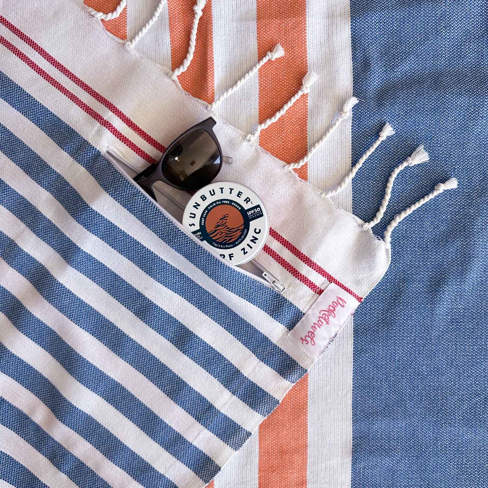 Simpson Beach Pocketowel, large beach towel with pocket, by Freostyle close up of pocket, orange, blue and white stripes