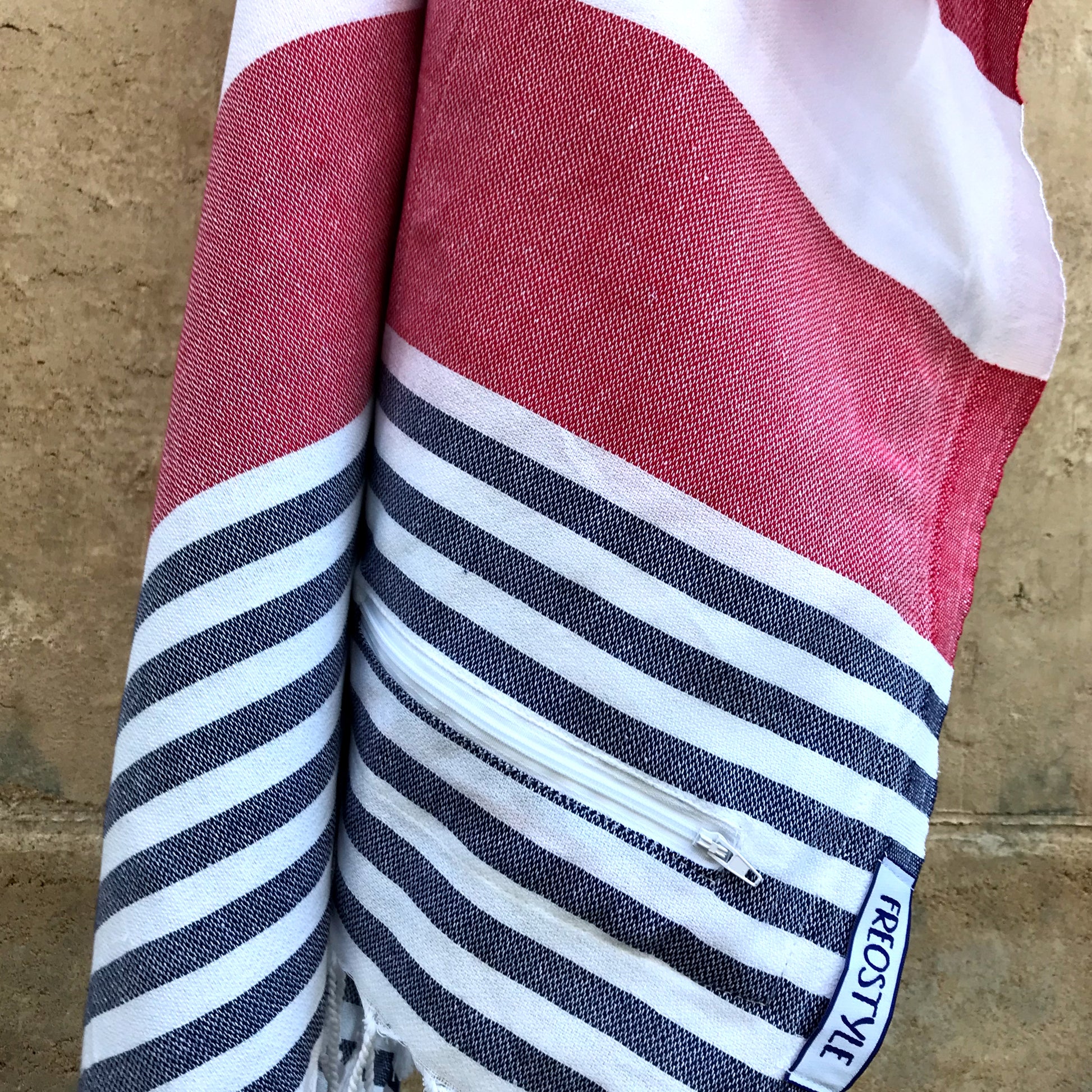 Antibes Turkish Towel with Pockets has a bold red feature stripe for a classic nautical feel