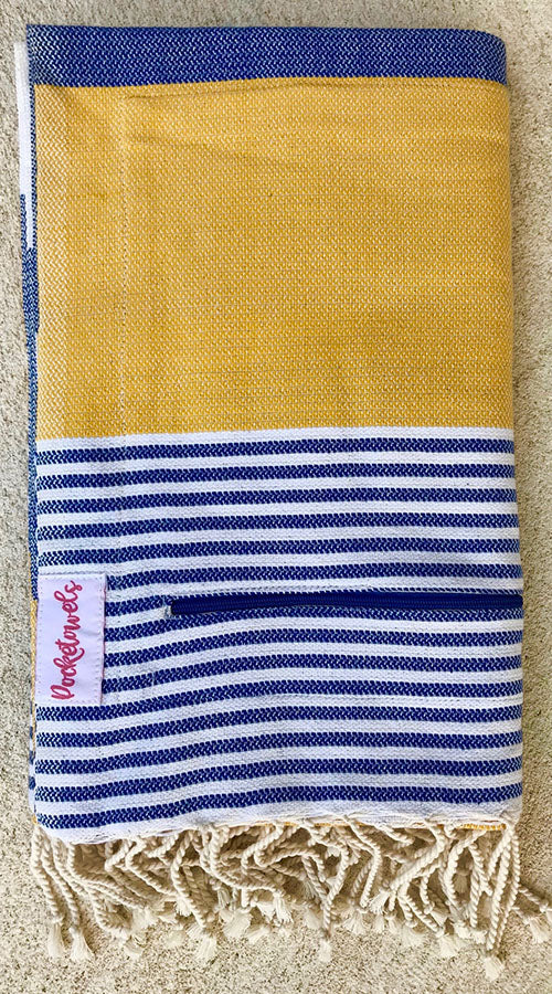 Arambol Pocketowel is navy and yellow stripe for a coastal vibe. Pocketowels are large beach towels with pockets