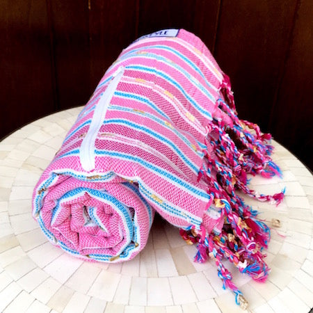 Our striped Berry turkish towel rolls up so small it is perfect for a day at the beach