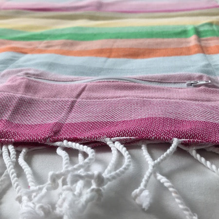 Ethically made Wildflowers turkish towel features hand-rolled tassels and a nifty hidden pocket